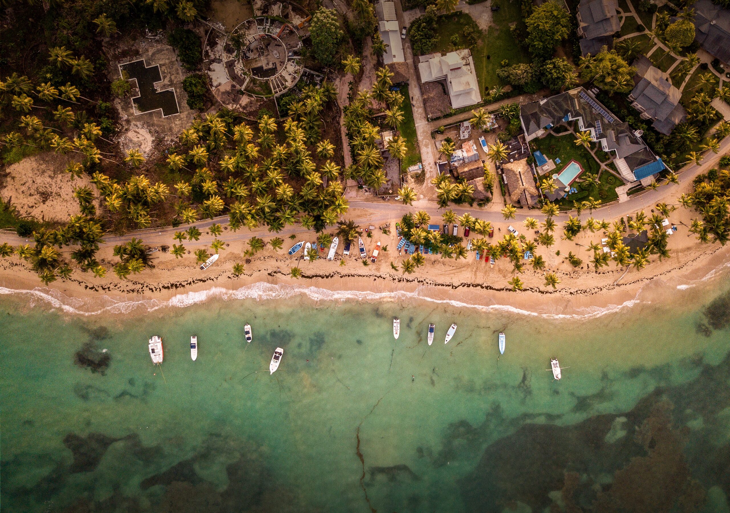 A beautiful overhead shot of houses and small boats parked near the seashore