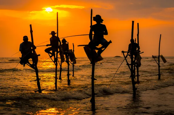 depositphotos_42152519-stock-photo-silhouettes-of-the-traditional-fishermen